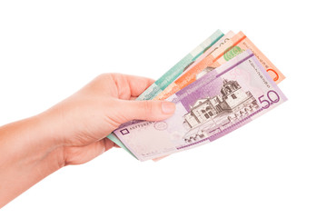 Dominican Republic money in female hand, close-up