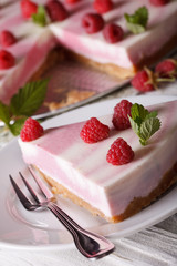 Slice of cheesecake with raspberries and mint close-up. Vertical
