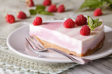 Slice of cheesecake with raspberries and mint close-up. horizontal
