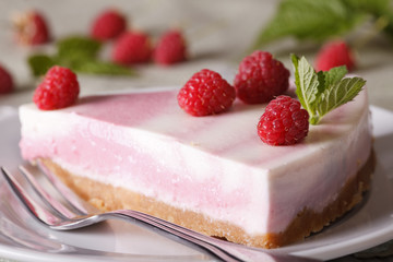 pink cheesecake with raspberries close-up on a plate. horizontal
