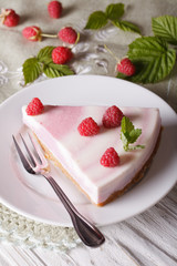 piece of raspberry cheesecake close-up on a plate. vertical top view

