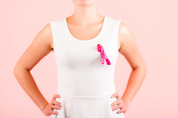 young woman wearing pink ribbon concept of breast cancer