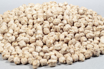 Uncooked dried chickpeas on gray background