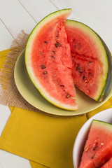 Watermelon slices on wooden vintage background.
