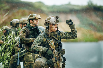 Military squad crossing the river