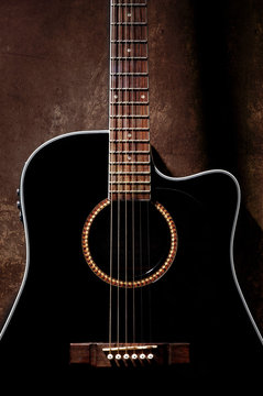 Detail of black acoustic guitar