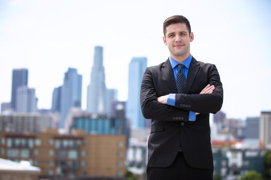 Young Business Man Attorney Arms Folded Proudly Standing In The City Building Background