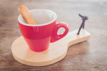 Red mug with wooden plate