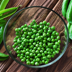 fresh green peas peeled in a glass bowl