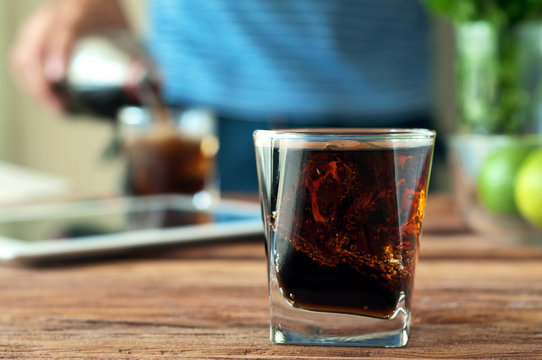 Cola in a glass with glass