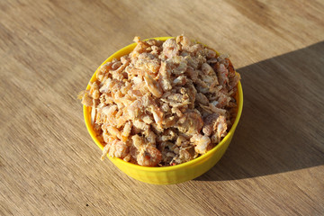 dried shrimp in yellow bowl isolated on wood background