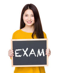 Woman hold blackboard showing a word exam