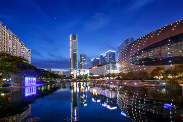 Illumintaed modern landmark and skyline at riverbank