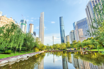 Fototapeta na wymiar Park and skyscrapers in modern city