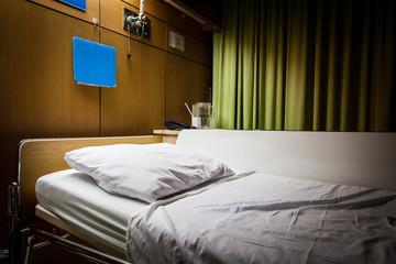 Fototapeta na wymiar Clean empty sickbed in a hospital ward