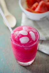 A glass of strawberry smoothie with sugar palm fruit