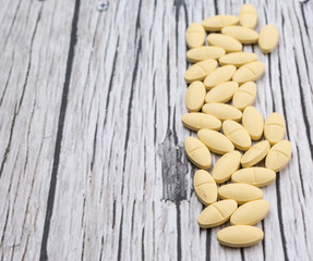 Medicinal pills over rustic wooden background
