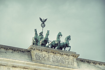 Fototapeta premium the bronze sculpture Quadriga on top of the Brandenburg Gate, Berlin, Germany, Europe, vintage style, Bronzeskulptur Quadriga auf dem Brandenburger Tor, Berlin, Deutschland 