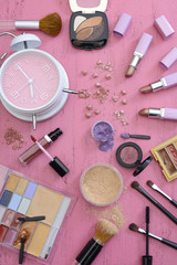 Fototapeta na wymiar Makeup Items on Vintage Pink Wood Table