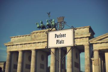 Obraz premium Pariser Platz sign and Brandeburg Gate (Brandenburger Tor), Berlin, Germany, Europe, vintage filtered style 