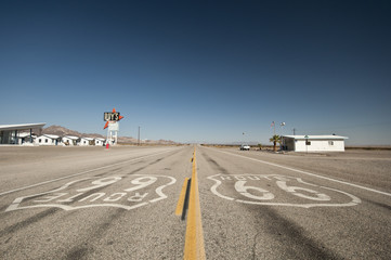 two Route 66 signs onthe road at California Mojave desert highway.