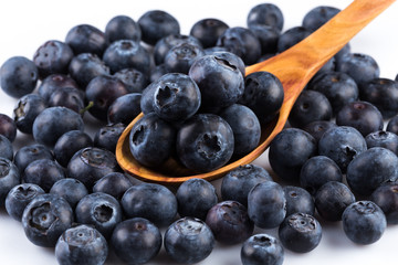 Fresh blueberries in wooden spoon