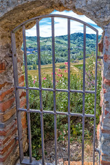 country views through Iron grating medieval window