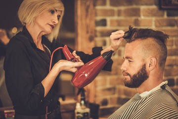 Client visiting hairstylist in barber shop