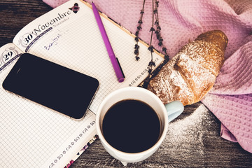Fresh croissant with cup of hot coffee