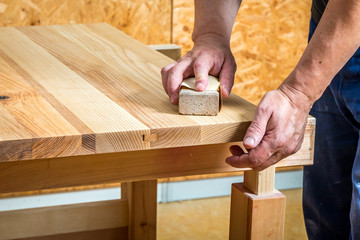 Carpenter sanding  a table