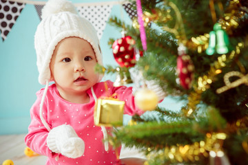 Newborn and Decorating Christmas tree on green background