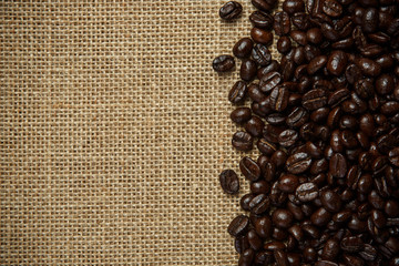 Coffee beans on burlap background
