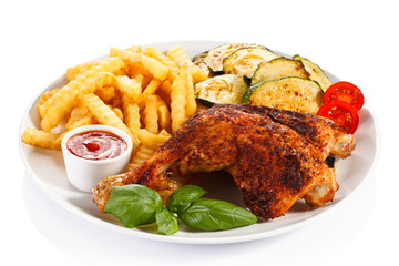 Grilled chicken legs with chips and vegetables 