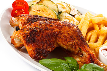Grilled chicken legs with chips and vegetables 