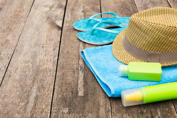 Summer beach essentials on old wooden background