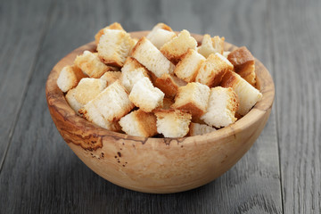 homemade croutons from white bread in wood bowl