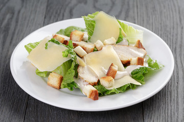 caesar salad with chicken on oak table