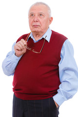 Portrait of thoughtful senior old teacher man, holds glasses in hand, wearing cardigan marsala color and shirt, isolated on white background. Human emotions and facial expressions. Education concept