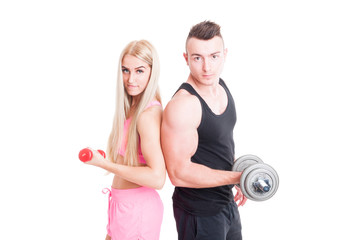 Beautiful and young fitness couple holding weights