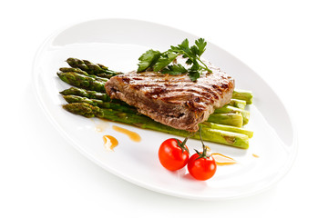 Grilled beefsteak and asparagus on white background