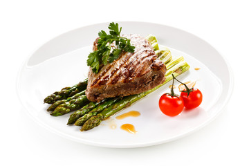 Grilled beefsteak and asparagus on white background