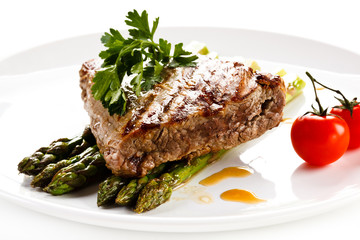 Grilled beefsteak and asparagus on white background