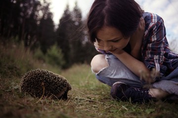 teenager girl playing with a hedgehog © kichigin19