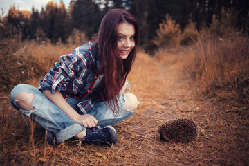 teenager girl playing with a hedgehog © kichigin19