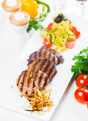 Grilled steaks with fresh vegetables