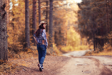 Fototapeta premium Fall forest landscape girl walk