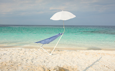 Sunbed and parasol on the beach