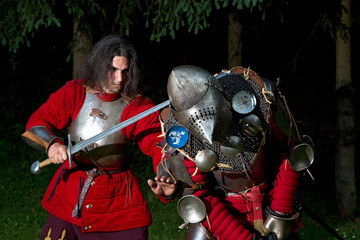 Two Knights Struggling For Survival in Dark Forest Closeup