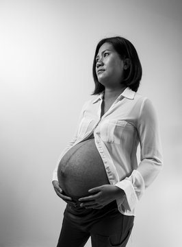 smart pregnant woman on gray background.