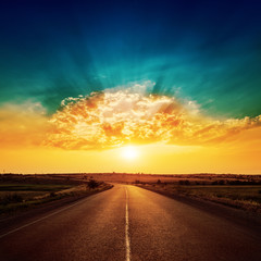 orange sunset and asphalt road to horizon